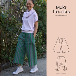 May include: Wide-leg trousers featuring vertical green and purple stripes, a buttoned hem detail, and side pockets. The image includes a technical line drawing of the Mula Trousers PDF sewing pattern with front and back views and text labels.