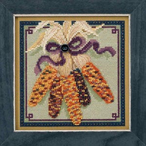 May include: A framed needlepoint artwork featuring a cluster of Indian corn. The corn is in shades of orange, yellow, and brown, with a purple ribbon and a button. The background is a light green, and the frame is dark blue.