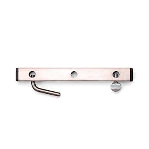 May include: A silver-colored metal door latch with a curved hook and a screw-on knob. The rectangular latch has three circular holes and black end caps. The hook is on the left side, and the screw is on the right.