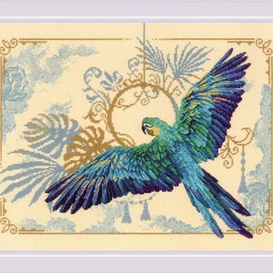 May include: Cross-stitch artwork of a vibrant parrot in flight, showcasing a spectrum of blues and greens. The bird's wings are spread wide, set against a backdrop of stylized foliage and a cream-colored background. The artwork is framed.