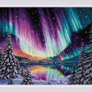May include: A cross-stitch pattern showing a vibrant aurora borealis display over a snowy landscape with silhouetted pine trees. The aurora is a mix of purple, green, and blue hues, reflecting in a still lake.