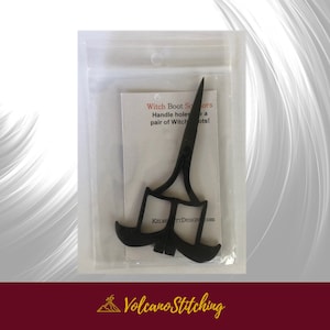 May include: Black witch boot scissors in a clear plastic bag with a white card that reads "Witch Boot Scissors Handle holes to make a pair of Witch Boots! KELMETTDESIGN.com"