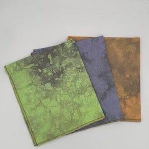 May include: Four fabric-covered notebooks with different tie-dye patterns in shades of green, brown, blue, and orange.