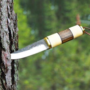 Handcrafted Fixed Blade Puukko knife. Puukko knife's craftsmanship and rugged design, suitable for camping, hunting, or bushcraft activities.