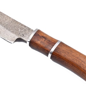 May include: A knife with a patterned steel blade and a brown wooden handle. The handle has a silver band around it.