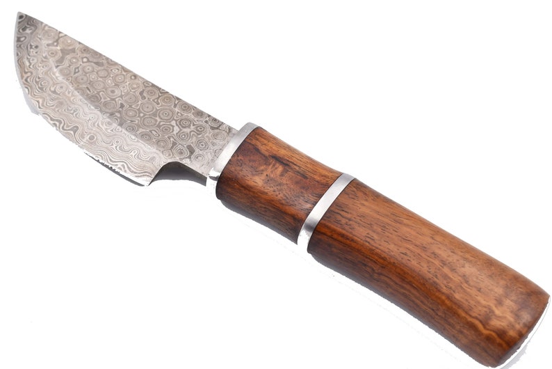 May include: A knife with a patterned steel blade and a brown wooden handle. The handle has a silver band around it.