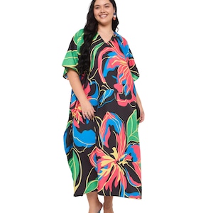 May include: A loose-fitting kaftan dress featuring a black base with a vibrant, large-scale floral print in shades of bright pink, electric blue, yellow, and green. The garment has a V-neckline, short wide sleeves, and a flowing, ankle-length silhouette.