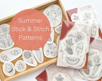 May include: A set of white felt patches with black line drawings of summer-themed designs, including a bee, a ladybug, a butterfly, a flower, a watermelon, an ice cream cone, a carrot, and a strawberry. The patches are arranged in a wooden tray and labeled "Summer Stick & Stitch Patterns".