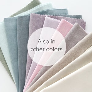 May include: A fan of fabric swatches in various shades of green, blue, pink, beige, and white. The text "Also in other colors" is visible in the center of the image.