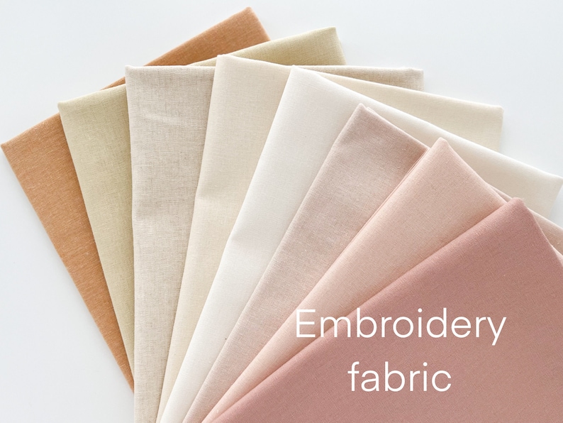 May include: A collection of eight different colored fabric swatches, ranging from light beige to a deep rose, with the text "Embroidery fabric" printed on the bottom right corner.