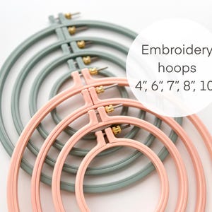 May include: Set of five embroidery hoops in pink and green, ranging in size from 4 inches to 10 inches.