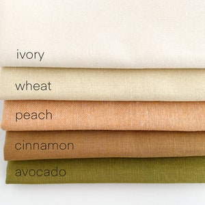 May include: Five fabric swatches stacked on top of each other. The swatches are ivory, wheat, peach, cinnamon, and avocado.
