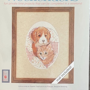 May include: A counted cross stitch kit featuring a dog and cat in a patchwork design. The kit includes 100% cotton Aida fabric, presorted floss, a needle, a designer organizer, and complete instructions. The finished size is 5 inches by 7 inches. The frame is not included.