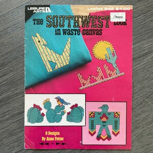 May include: A vintage craft leaflet titled "The Southwest in Waste Canvas" by Leisure Arts. The cover features colorful cross-stitch designs of cacti, a sun, a bird, and a stylized bird. The leaflet includes 9 designs by Anne Fetzer.
