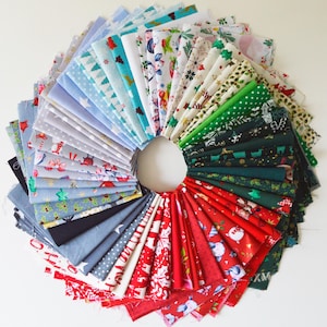May include: A collection of 40 fabric squares in various Christmas-themed patterns. The squares are arranged in a fan shape, with the colours red, green, blue, and white. The fabrics feature a variety of designs, including snowflakes, reindeer, and Christmas trees.