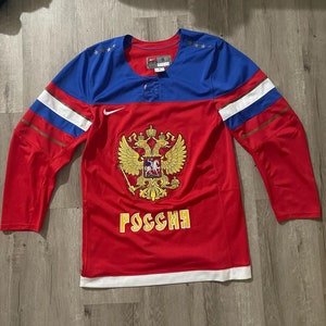 May include: Red, white, and blue hockey jersey with the Russian coat of arms and the word "Россия" on the front. The jersey has a Nike logo on the sleeve.