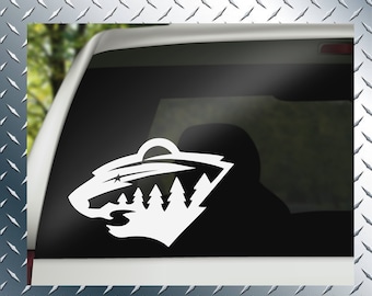 May include: White vinyl decal of the Minnesota Wild NHL hockey team logo. The logo features a stylized bear's head with a forest scene and a star in the sky.