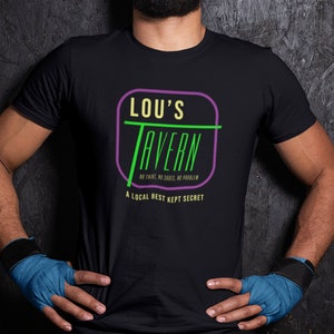May include: A black t-shirt with a green and purple logo that says "Lou's Tavern" with the text "No shirt, no shoes, no problem" and "A local best kept secret".