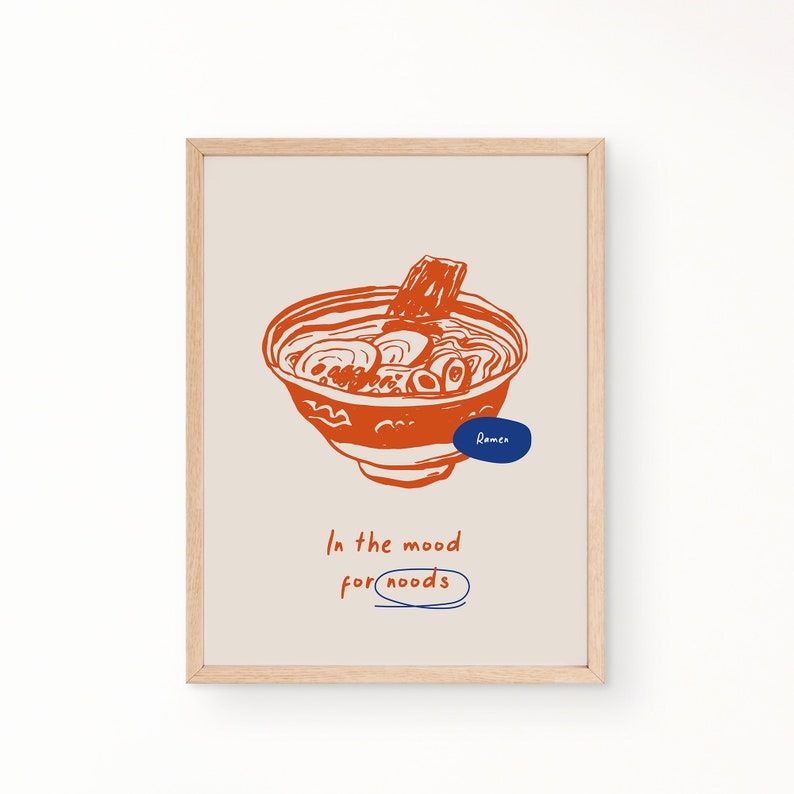 May include: A framed print with a hand-drawn illustration of a bowl of ramen noodles. The text "In the mood for noodles" is written below the bowl.