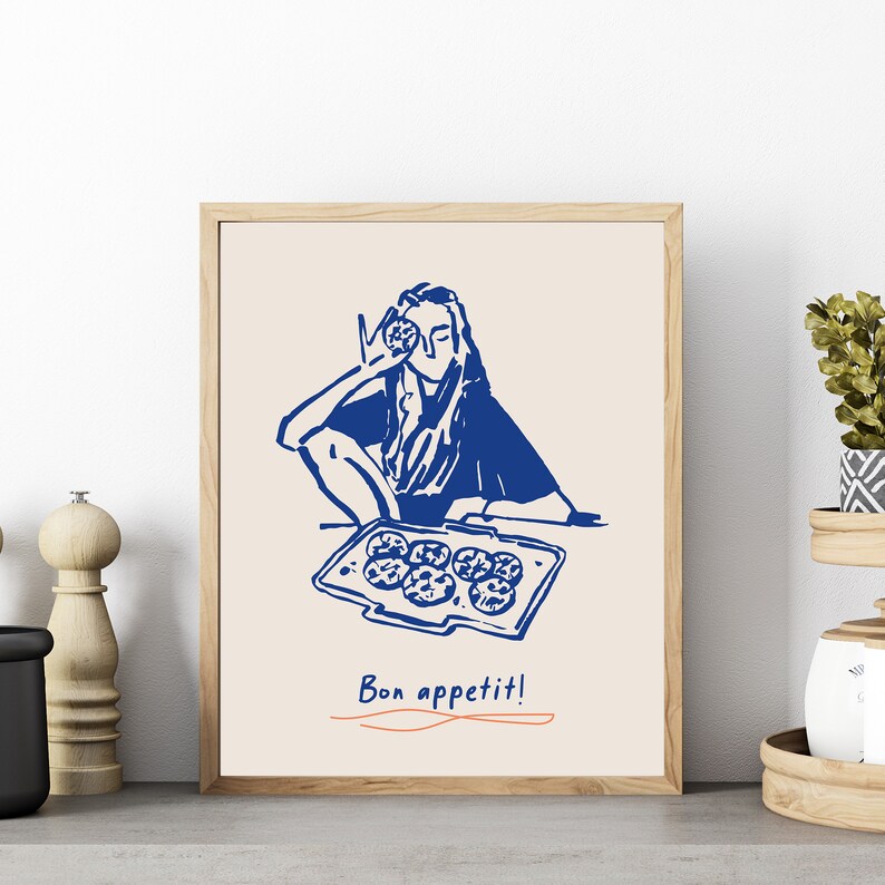 May include: A blue and white illustration of a person holding a cookie in front of their face, with a tray of cookies in front of them. The text "Bon appetit!" is written below the image.