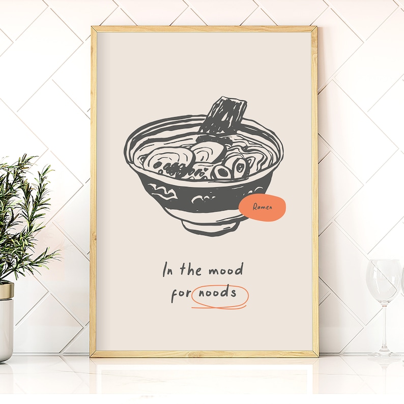 May include: A beige poster with a black and white illustration of a bowl of ramen noodles. The text "In the mood for noodles" is written below the illustration.