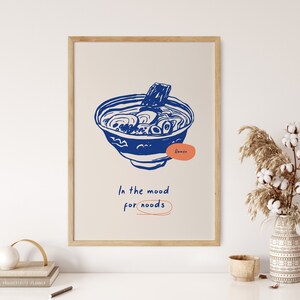 May include: A blue and white illustration of a bowl of ramen noodles with the text "Ramen" and "In the mood for noodles" on a white background.