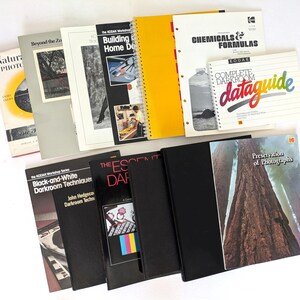 Könnte beinhalten: Eine Sammlung von Lehrbüchern zur Fotografie und Dunkelkammerarbeit, darunter Titel wie Natural Photography, Chemicals & Formulas und der Kodak Complete Darkroom Dataguide, mit verschiedenen Einbänden, Texten und Abbildungen.
