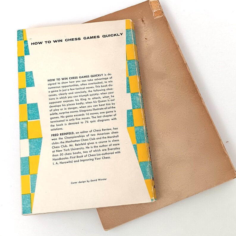 May include: A vintage book titled "How to Win Chess Games Quickly" by Fred Reinfeld. The book cover features a yellow and blue checkered pattern and text describing the author and the book's contents.