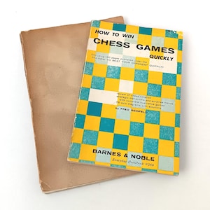 May include: A yellow and blue book titled "How to Win Chess Games Quickly" by Fred Reinfeld. The book is a Barnes & Noble Everyday Handbook #269.