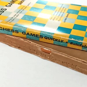 May include: A yellow and blue book titled "How to Win Chess Games Quickly" by Fred Reinfeld. The book is published by Barnes & Noble.