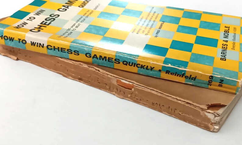 May include: A yellow and blue book titled "How to Win Chess Games Quickly" by Fred Reinfeld. The book is published by Barnes & Noble.