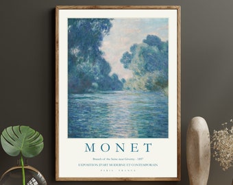 May include: A framed print of a painting by Claude Monet titled "Branch of the Seine near Giverny, 1887". The painting depicts a river scene with trees and water in shades of blue and green. The text "MONET" is printed below the painting, along with the title and date. The text "EXPOSITION D'ART MODERNE ET CONTEMPORAIN PARIS FRANCE" is printed below the title and date.