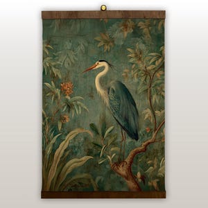 May include: A vintage-style wall hanging featuring a detailed illustration of a heron perched on a tree branch. The artwork is set against a teal background with floral and foliage elements. The heron has a long neck and beak, with shades of blue and gray in its feathers. The frame is a dark brown.