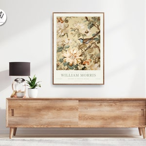 May include: A vintage-style poster featuring a floral design with a bird perched on a branch. The poster is titled "The Art of William Morris" and features a muted color palette of beige, brown, and green.