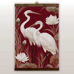 May include: A wall hanging featuring a watercolor illustration of two white herons with long necks and beaks, set against a deep red background. The artwork includes white lotus flowers and foliage, framed by a dark wood border.