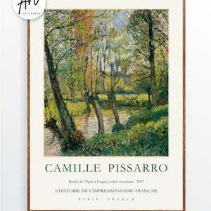 May include: A painting by Camille Pissarro titled "Bords de l'Epte &agrave; Eragny, soleil couchant - 1897". The painting depicts a river scene with trees and foliage in shades of green, yellow, and blue. The painting is framed in a brown wooden frame.