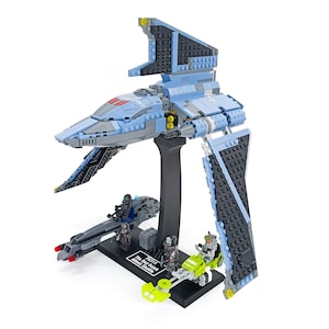 Op de afbeelding: Een blauwe en zwarte Lego Star Wars The Bad Batch Attack Shuttle set met vier minifiguren, een speeder en een displaystandaard. De set bevat de tekst "75314 The Bad Batch Attack Shuttle".