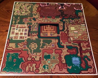 May include: A detailed map of the overworld from the classic video game The Legend of Zelda. The map features a variety of terrain, including forests, mountains, and water. The map is printed on a white background.