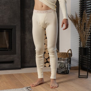 May include: A pair of off-white thermal underwear with a pink waistband that says "MENIQUE".