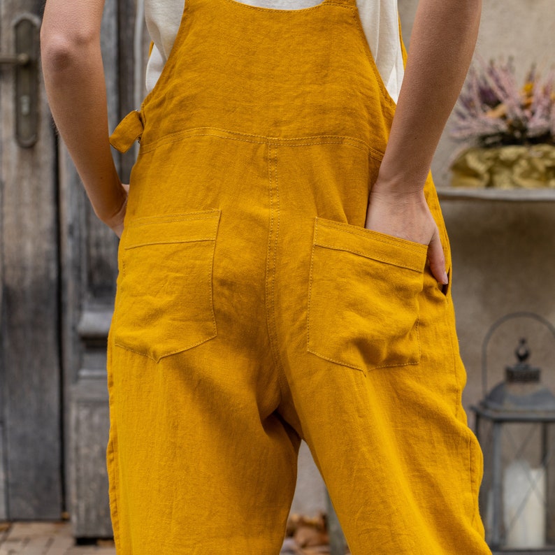 In the photograph the model is wearing the linen jumpsuit NICCI in spicy yellow color.