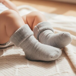 Baby wearing Merino Wool Sherpa Socks in the color light gray