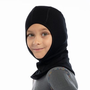 May include: A black fleece balaclava for kids. The balaclava covers the head and neck, with an opening for the face.