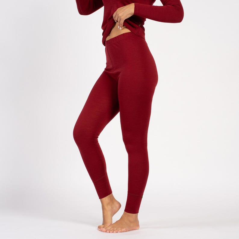 Side detail of royal cherry Merino wool thermal leggings, high-waist fit.