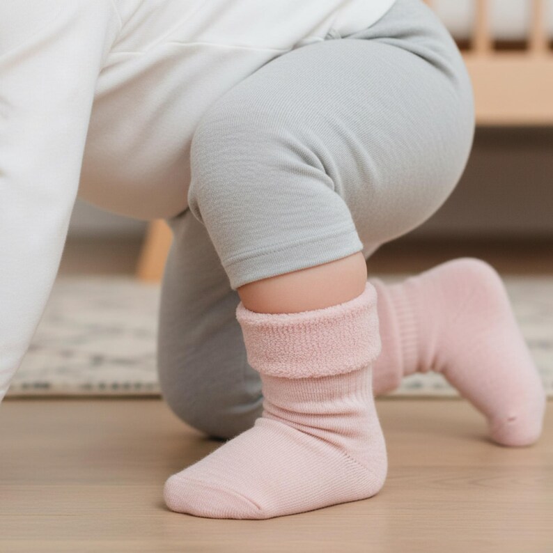 Baby wearing Merino Wool Sherpa Socks in the color pink