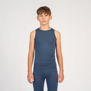 May include: A young person wearing a blue sleeveless undershirt and matching blue pants.