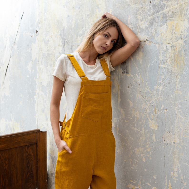In the photograph the model is wearing the linen jumpsuit NICCI in spicy yellow color.