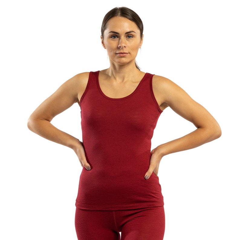 May include: A red sleeveless tank top made of a soft, comfortable fabric. The tank top has a scoop neck and a relaxed fit.