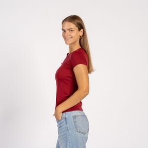 Side view of model wearing royal cherry Merino T-shirt – soft lightweight wool tee