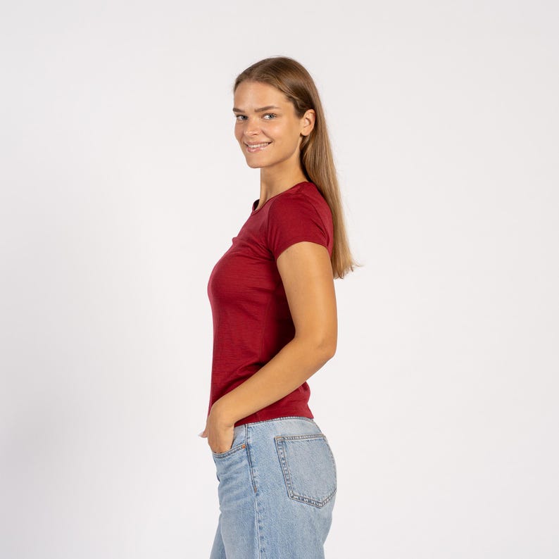 Side view of model wearing royal cherry Merino T-shirt – soft lightweight wool tee