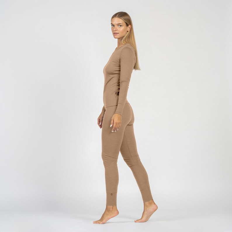 Woman wearing a beige bodysuit on a white background